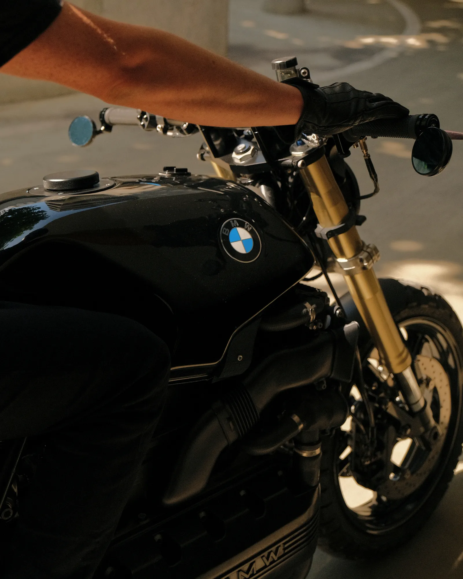 Close view over the tank of the K1100 showing the CNC fuel cap, gold R1 fork leg and headlight clamps