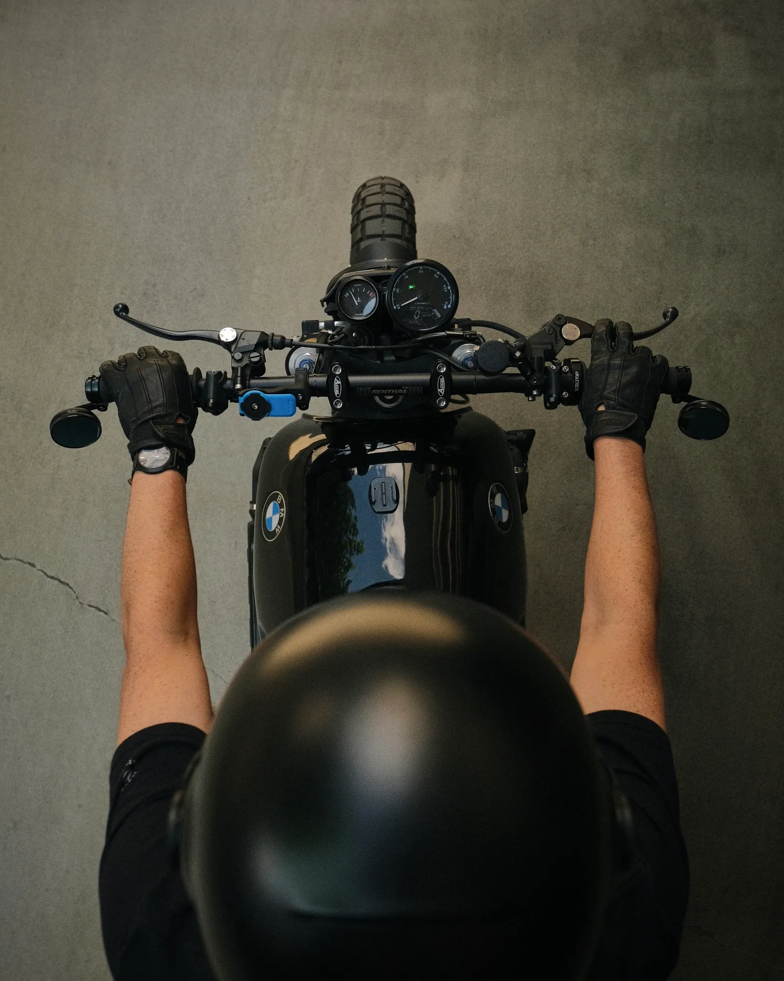 Top-down rider view of the Renthal handlebar with temperature gauge and Tenet speedo on the black tank