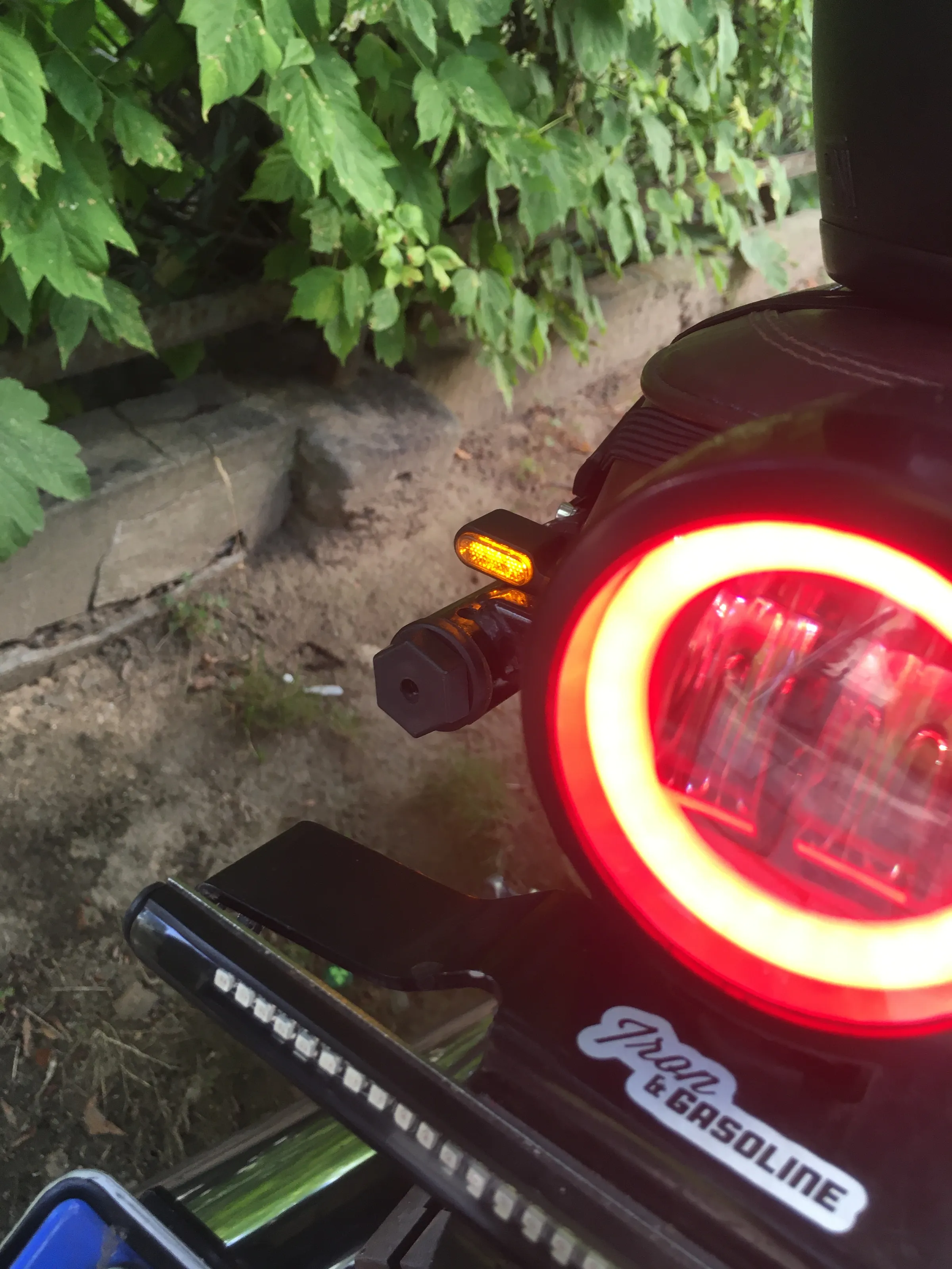 The rear LED halo taillight glowing red above the carbon-covered 3D printed rear mudguard