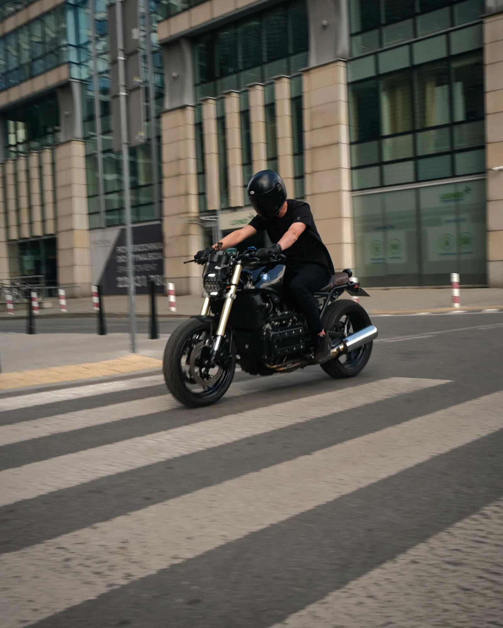Panning shot of the K1100 riding across a zebra crossing in central Warsaw