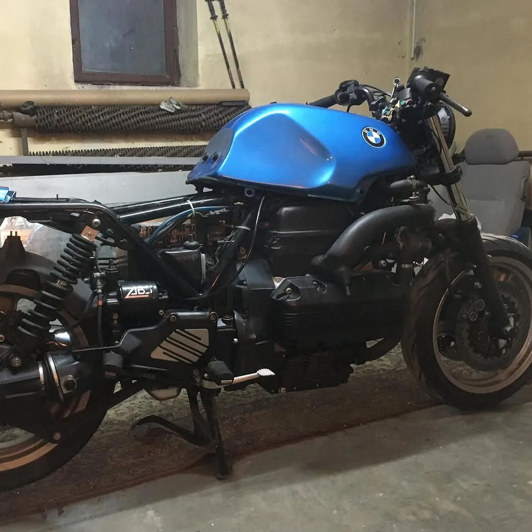 The K1100 stripped of its fairing in the rented Lodz garage, blue tank still on, wiring exposed