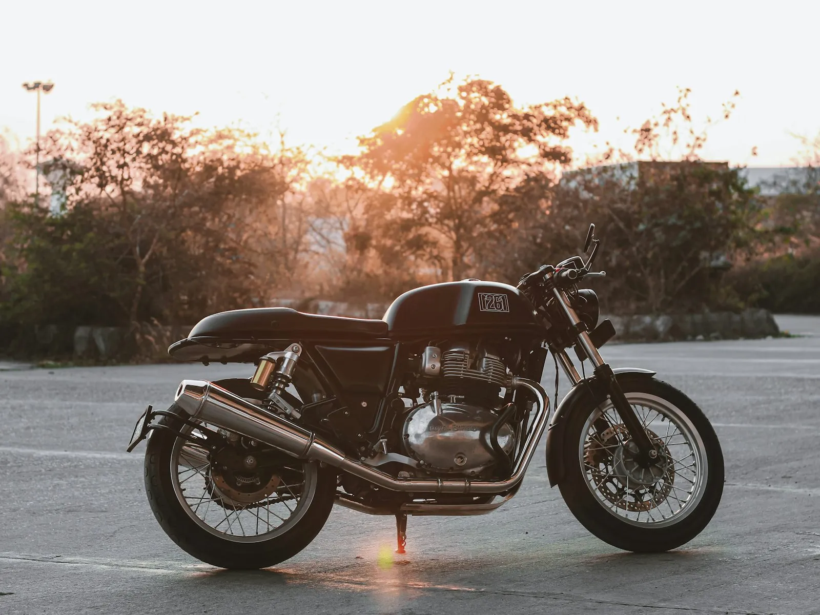 Cafe racer motorcycle in profile at golden hour