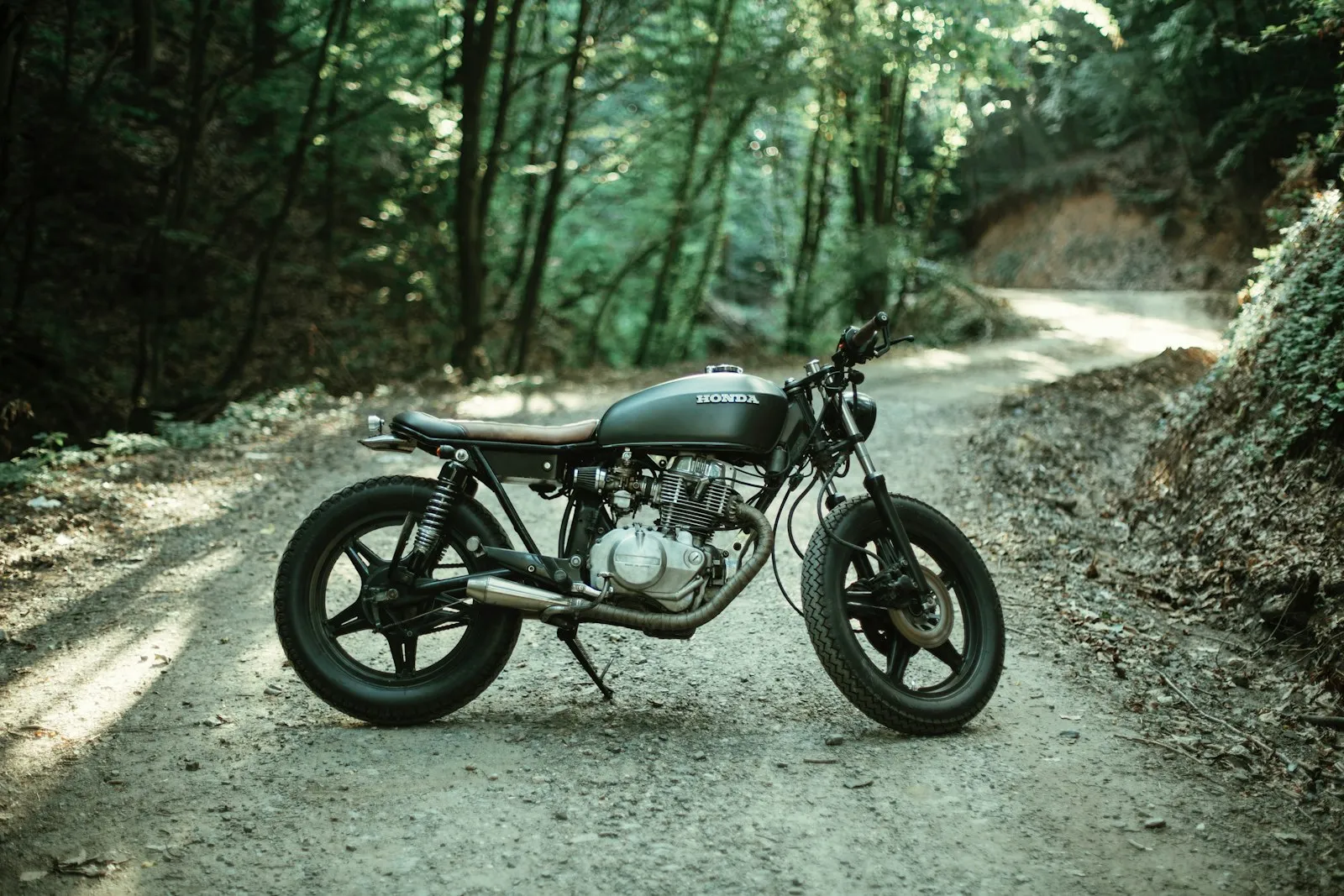 Scrambler motorcycle on a forest trail